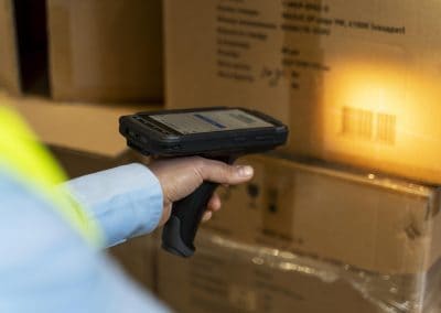 Edgeworks inventory system in action: Person scanning barcode with stock gun for streamlined inventory management.