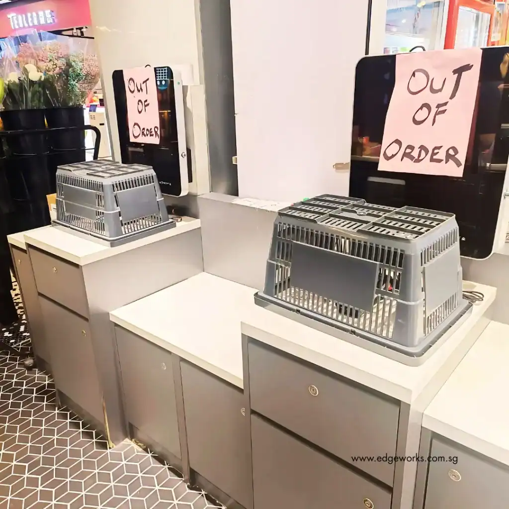 An image showing fully functional checkout kiosks labelled as 'out of order'