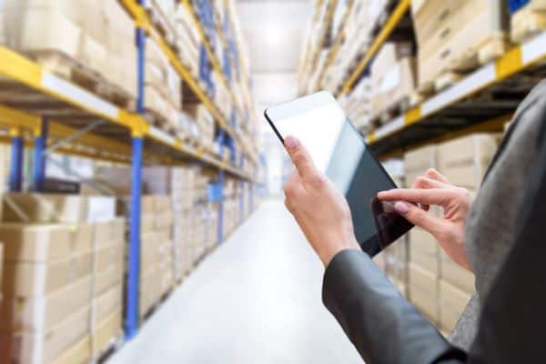 Warehouse staff using PDAs to efficiently track and manage inventory. Experience seamless control with Edgeworks Solutions' inventory management system.