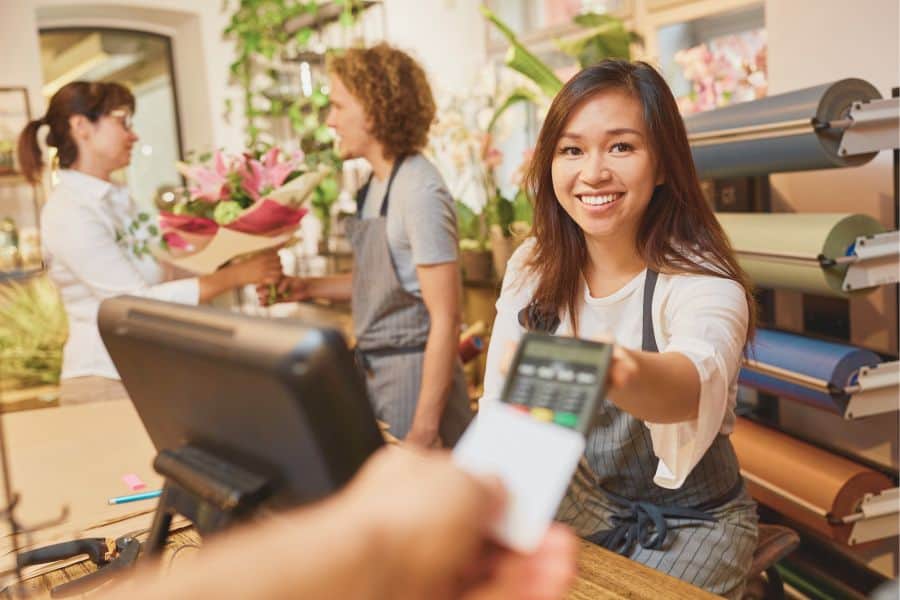 Smiling salespersons at the counter, delivering excellent service to customers with the efficiency of an omnichannel Retail POS System, EquipPOS Retail. Elevating the shopping experience, seamlessly.