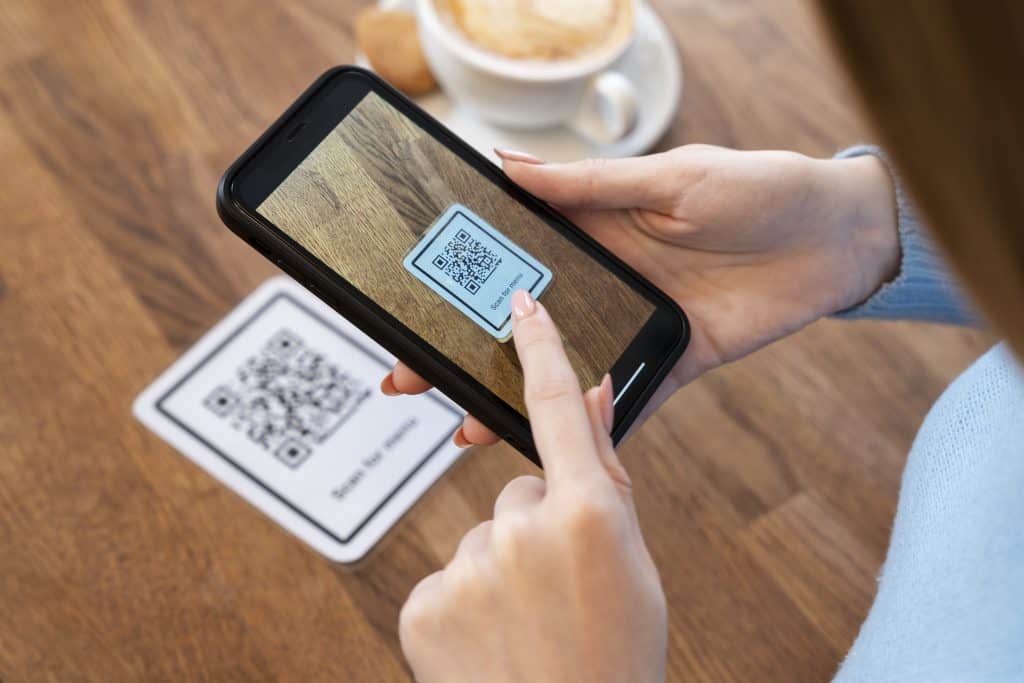 A person scanning a QR code with a mobile phone to effortlessly place an order. Embrace the future of convenience with our online ordering system.