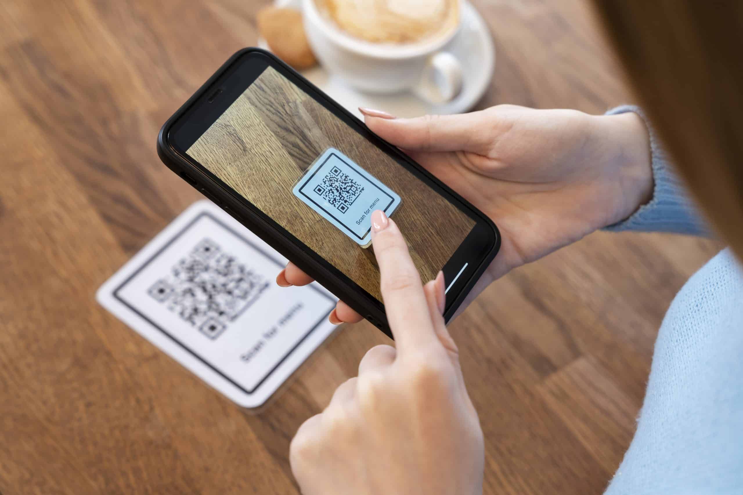 A person scanning a QR code with a mobile phone to effortlessly place an order. Embrace the future of convenience with our online ordering system.