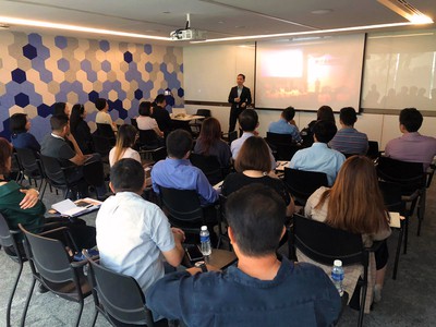 A presenter passionately engaging a diverse and attentive audience during a workshop as part of Edgeworks Solutions' customer training program. This image embodies Edgeworks' commitment to collaborative growth and a dynamic business approach.