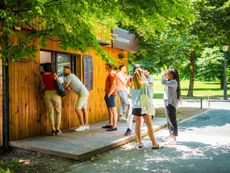 A group of customers waiting patiently outside a cafe to place an order